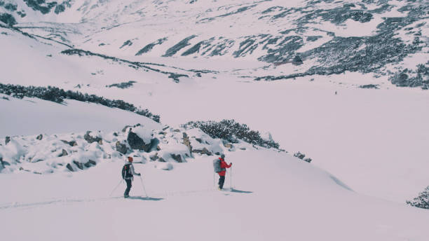 istock Winter mountain adventure. Young couple on a trail 1140390795