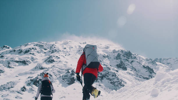 istock Winter mountain adventure. Young couple on a trail 1140390802
