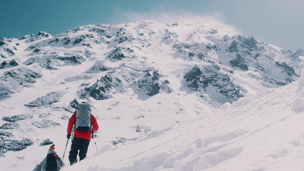 istock Winter mountain adventure. Young couple on a trail 1140390803