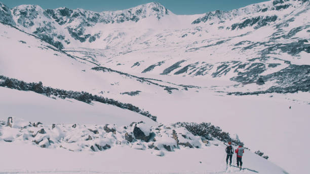 istock Winter mountain adventure. Young couple on a trail 1140390804