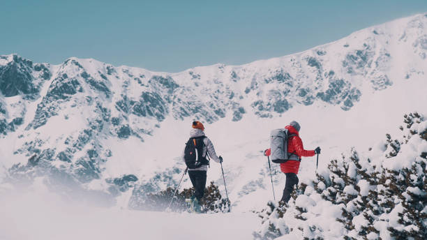 istock Winter mountain adventure. Young couple on a trail 1140390808