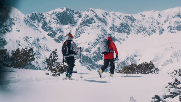 istock Winter mountain adventure. Young couple on a trail 1140390816