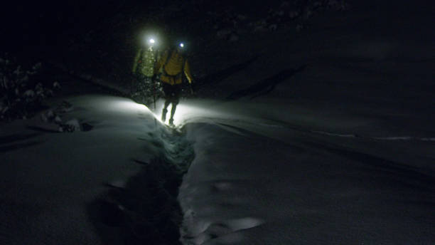 istock Winter mountain adventure. Young couple on a trail. Night blizzard 1140390905