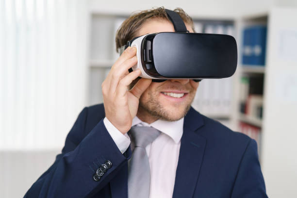 istock Young man in suit wearing VR headset 1140392992
