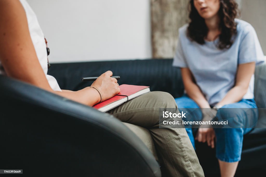 Psychotherapy session, woman talking to his psychologist in the studio Psychotherapy Stock Photo