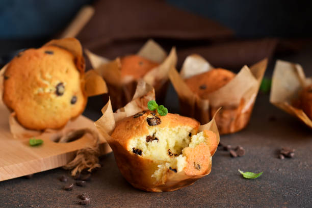 istock Muffins with chocolate chunks on the kitchen table with space for text. View from above 1140393926