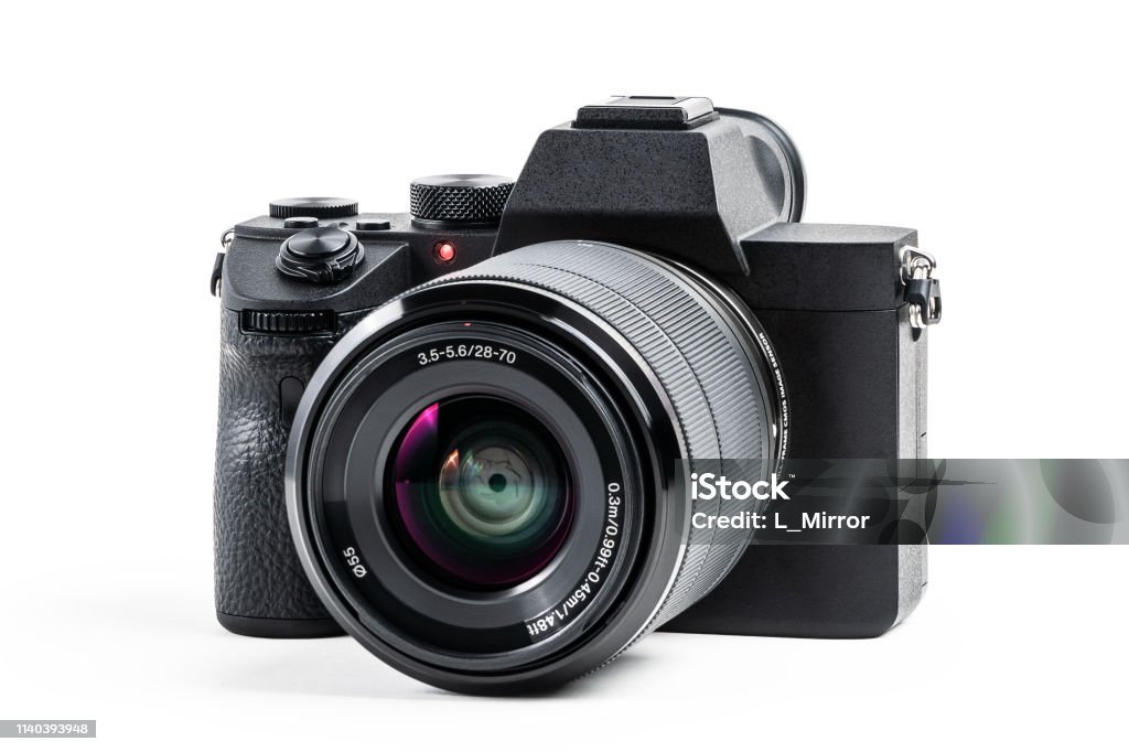 Camera isolated on white background with clipping path. Mirrorless camera isolated on white background. Clipping path for design and artwork. Camera - Photographic Equipment Stock Photo