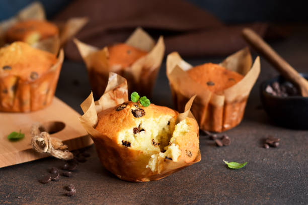 istock Muffins with chocolate chunks on the kitchen table with space for text. View from above 1140394196