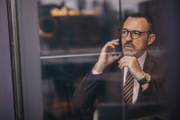 istock Elegant senior man is using smart phone 1140394516