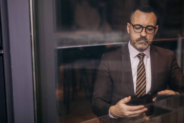 istock Senior businessman is texting 1140396220
