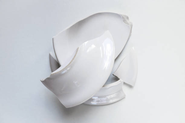 istock pile of broken white plate on light background 1140396492
