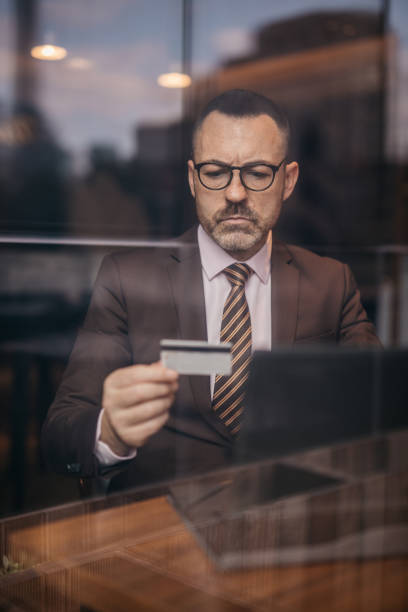 istock Senior businessman using credit card and laptop 1140396525