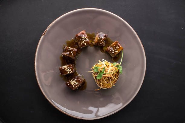 istock Japanese Food Unagi roll on grey plate on black background 1140397621