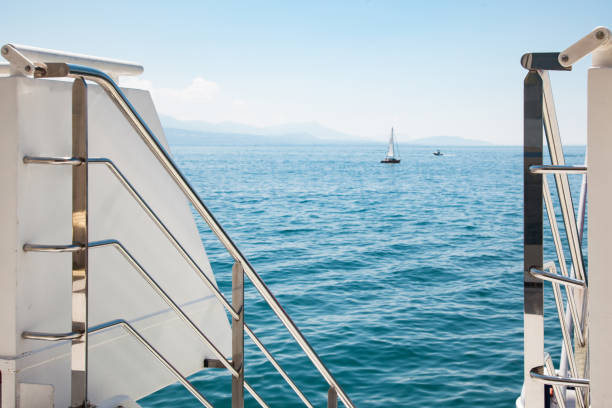 Modern boat open deck railing with view of Lake Leman (Geneva Lake) on beautiful sunny summer day