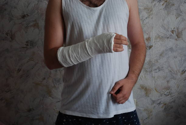 a man with a broken arm in everyday home clothes, a cast