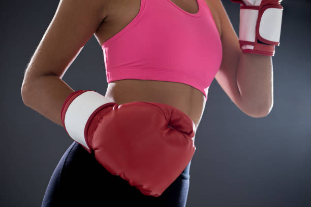 istock woman posing in boxing gloves 1140399187