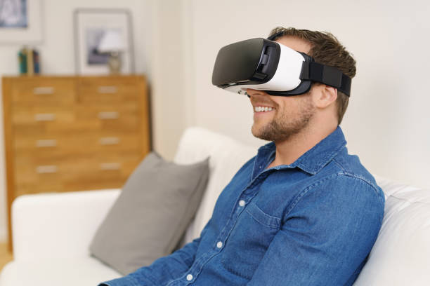istock Happy bearded man looking through VR glasses 1140399351