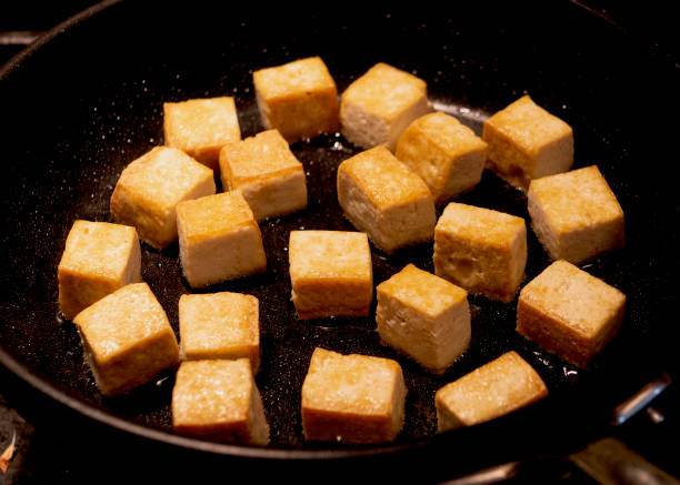 istock Tofu cubes fried in pan atop gas stove 1140401152