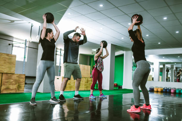istock Instructor Showing Class How To Workout With Fitness Ball 1140402588