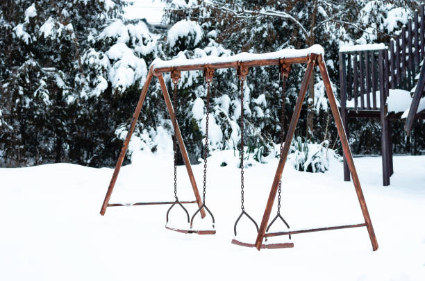 istock An old aged rusty  iron double swing  for children covered with snow in  park 1140404674