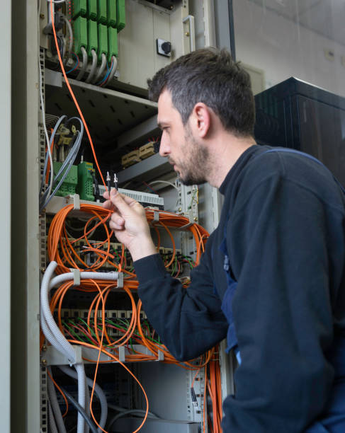 istock Engineer connecting fiber optic cable to the switch 1140405690