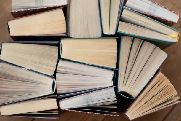istock Many Books Piles. Hardback books on wooden table. 1140410191