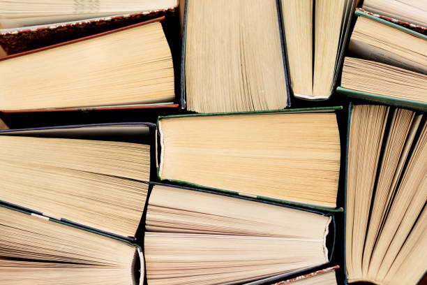 istock Many Books Piles. Hardback books on wooden table. 1140410193