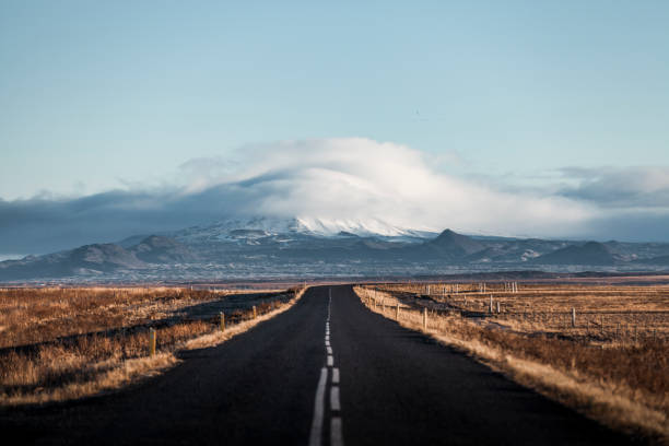 endless lonely country road to the glaciers of iceland long road in one straight direction in iceland. golden circle route photos stock pictures, royalty-free photos & images