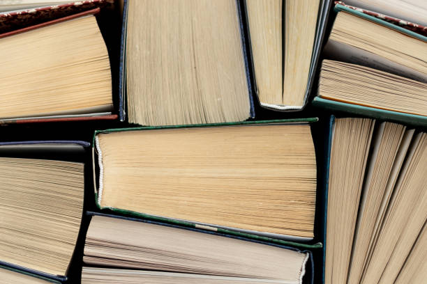 istock Many Books Piles. Hardback books on wooden table. 1140410331
