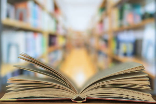 istock Open book on the desk in the library room 1140410352