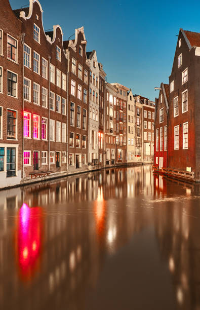 istock Canal between buildings at night in Amsterdam 1140411767