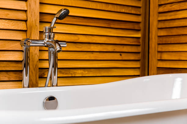 istock Bathroom with bath, shower and wooden backgrounds 1140412278