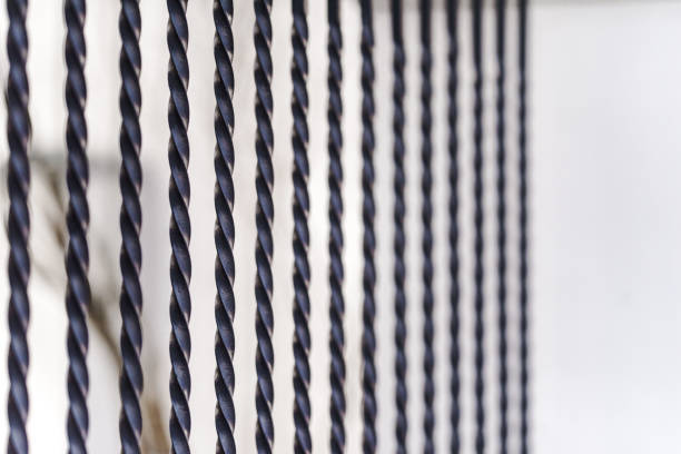 New fence made of painted metal rods with concrete posts. The background is blurred.
