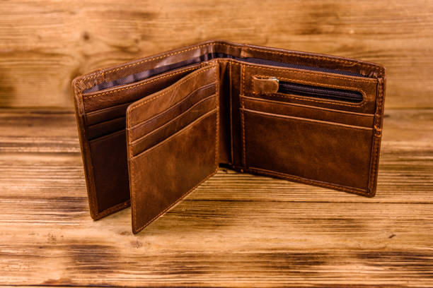 istock Opened brown leather wallet on wooden table 1140416038