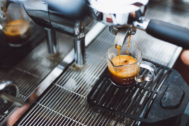 istock fresh espresso flow to a glass on espresso machine. 1140419129