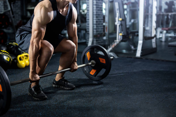 istock fit man make sport exercise with barbell. 1140419131