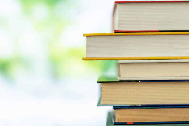 istock Multikolor book stack in the library room on tabel and blurred trees on street back to school concept 1140419797