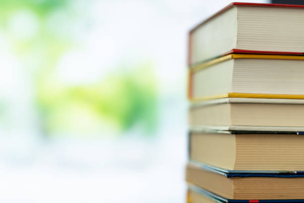 istock Book stack in the library room on tabel and blurred trees on street back to school concept 1140419810