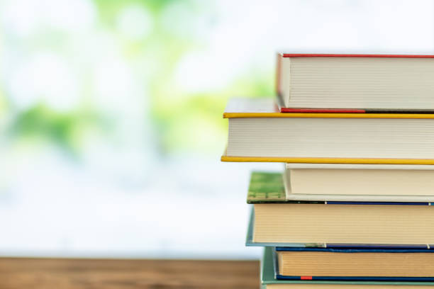 istock Book stack in the library room on tabel and blurred trees on street back to school concept 1140419813