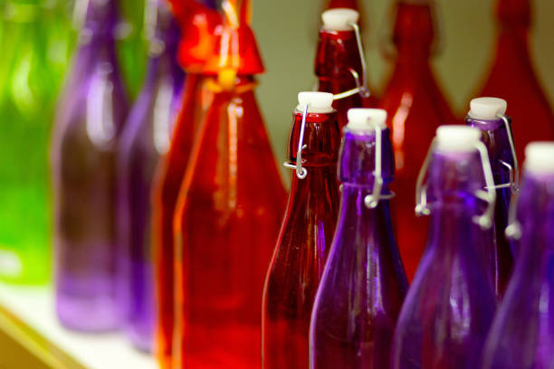 istock Multicolored glass bottles on the shelf in the store 1140420861