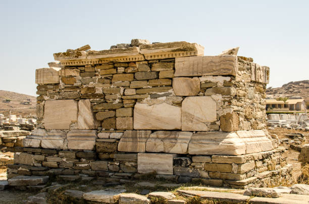 ruins of classical greek architecture carved in marble on the island of delos near mykonos in greece