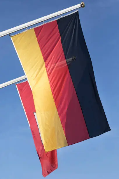 german flag in front of a flag of Hamburg