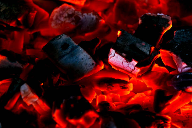istock Burning firewood in the fireplace close up, BBQ fire, charcoal background. Charcoal fire with sparks. Fire background. Close up 1140425690