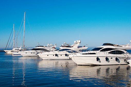 White yachts in port.