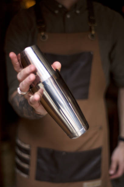istock Professional male bartender holding a steel shaker 1140431076