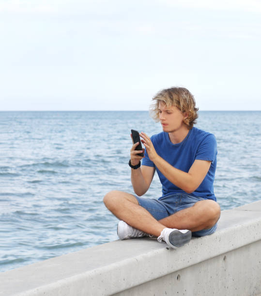 istock Teenage boy typing text message.Using smart phone. 1140432116
