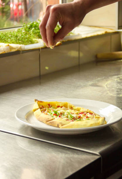 istock man hand sprinkles pizza with parsley 1140432880