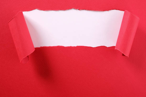 istock Torn red paper strip curled edge revealing white background 1140433695