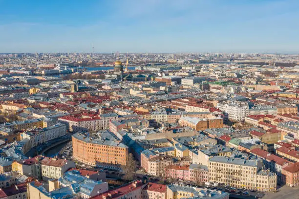 Aerial view roofs of old houses in the center of St. Petersburg, in the distance St. Isaac's Cathedral, Peter-Pavel's Fortress