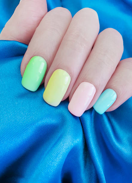 istock female hand manicure colored silk fabric 1140440529